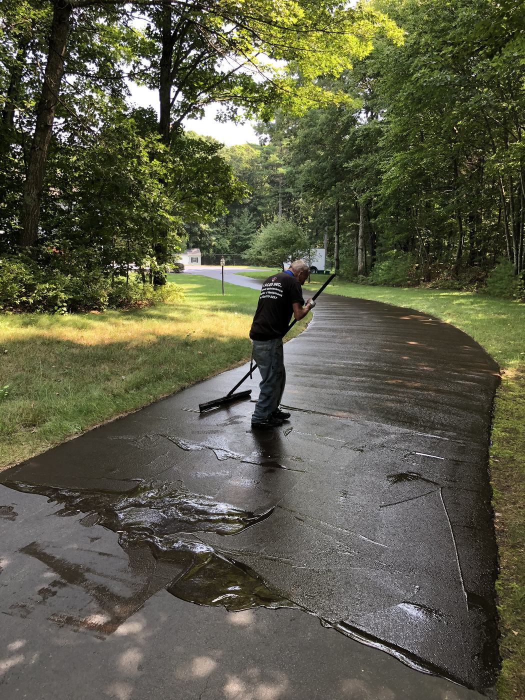 Freshly sealcoated residential driveway with rich black finish