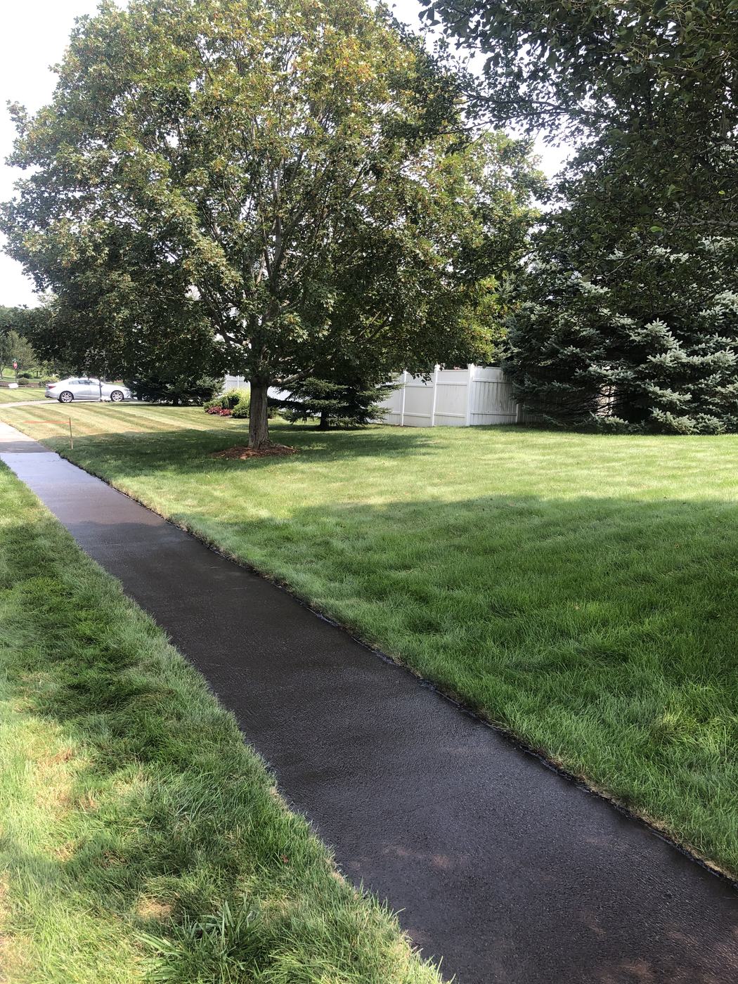 Driveway sealcoating with precise edge work