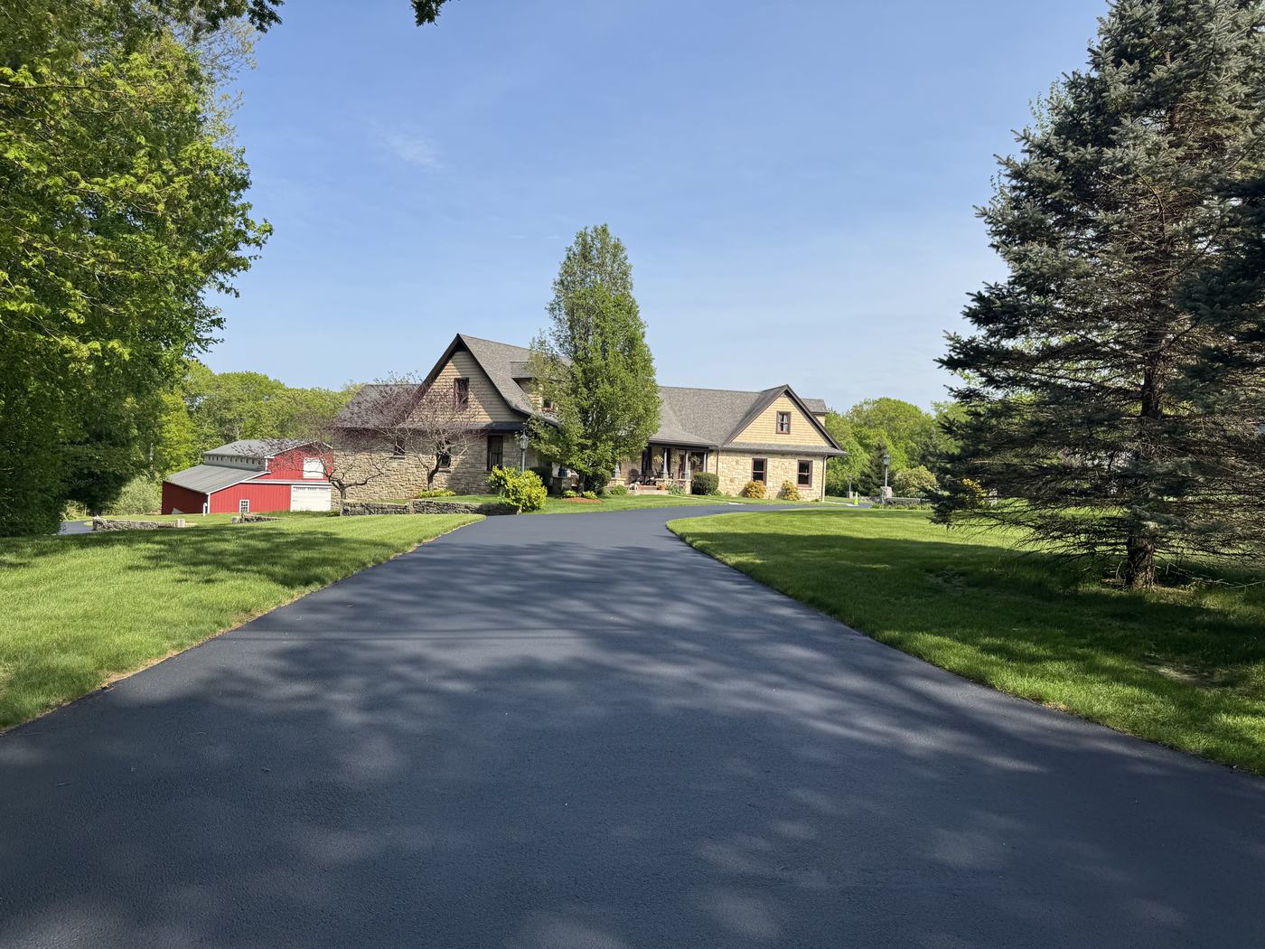 Wide driveway freshly sealed with rich black coating
