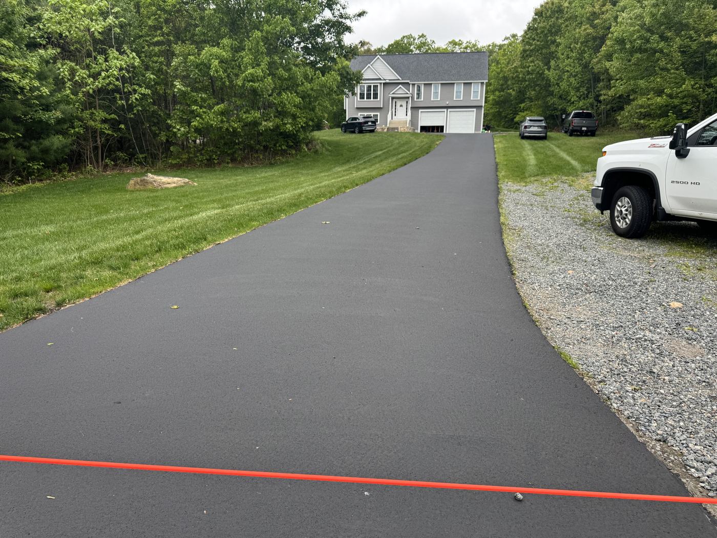 Wide view of a freshly sealed residential driveway