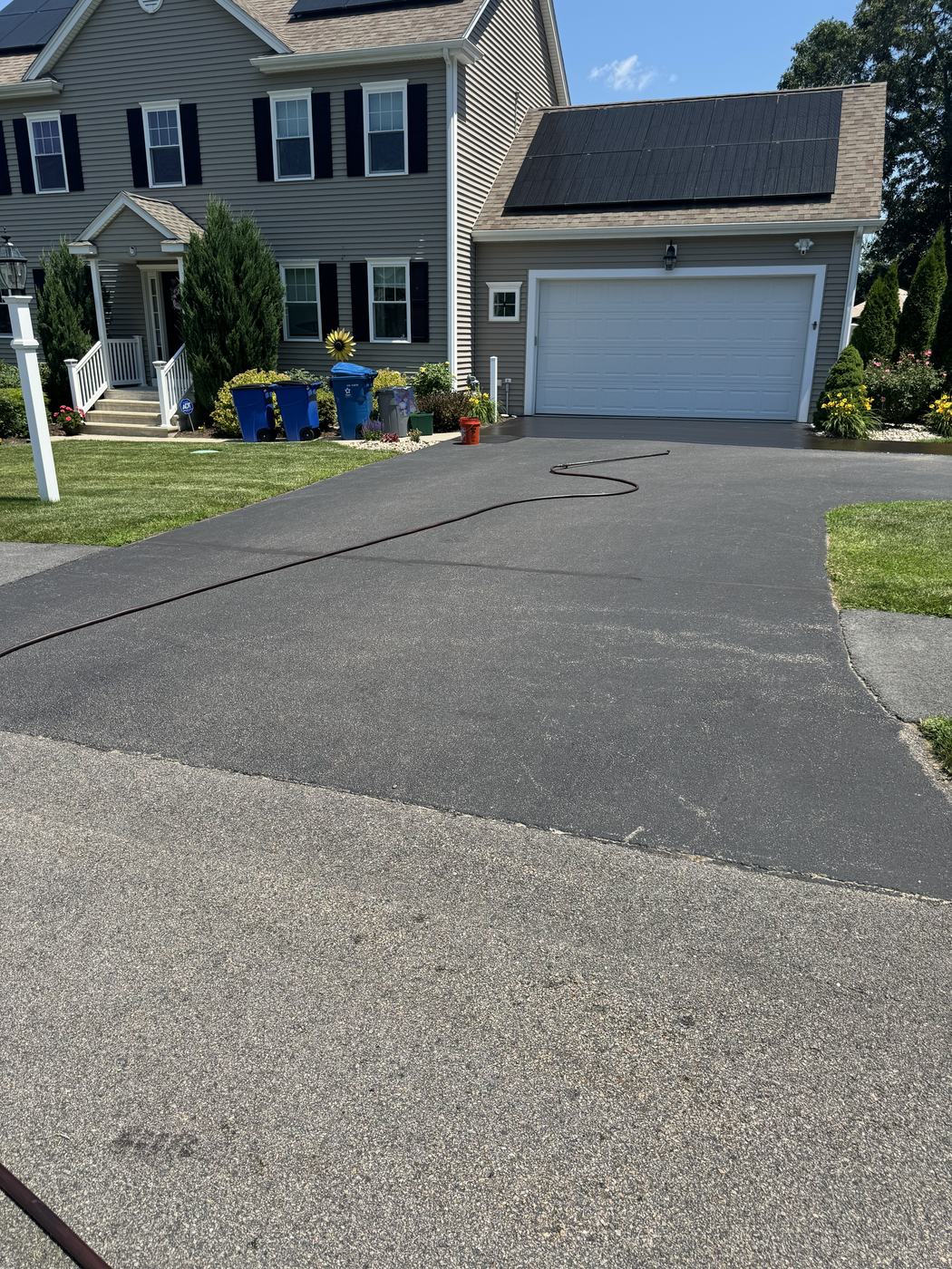 Residential asphalt driveway protected with fresh sealcoat