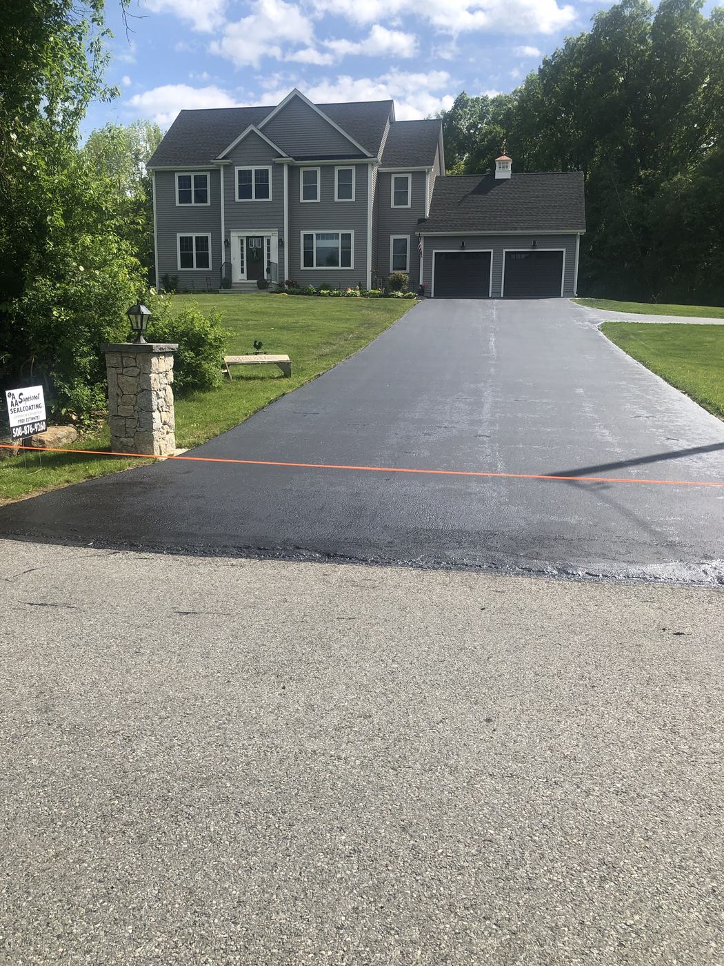 Newly sealed home driveway with crisp edges